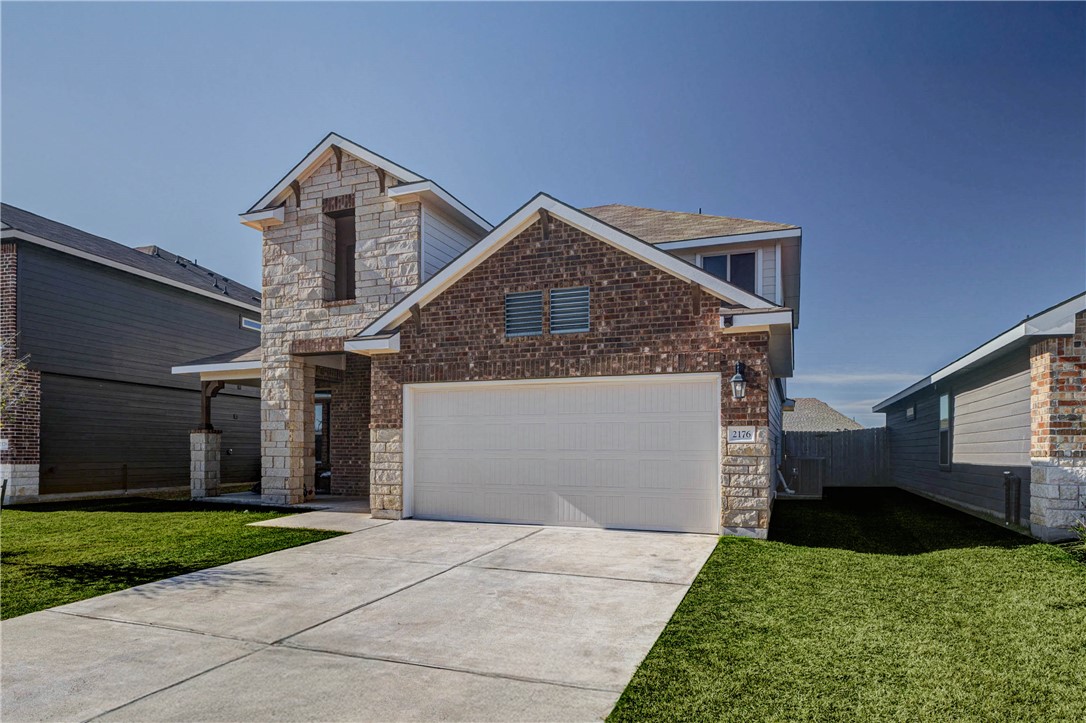 2176 Chief Street Bryan, TX 77807 - Photo 3 of 21 a front view of a house with a yard and garage