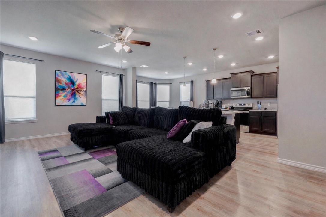 2176 Chief Street Bryan, TX 77807 - Photo 4 of 21 a living room with furniture and a chandelier