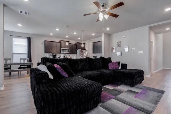 a living room with furniture and a chandelier