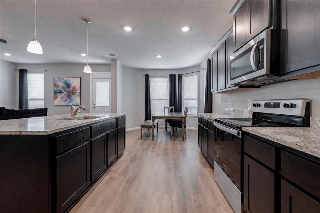 2176 Chief Street Bryan, TX 77807 - Photo 6 of 21 a kitchen with stainless steel appliances granite countertop sink stove top oven and cabinets
