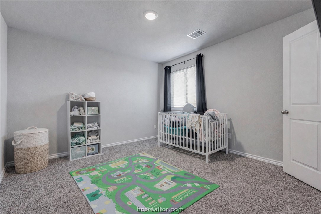 2176 Chief Street Bryan, TX 77807 - Photo 10 of 21 a bedroom with a bed and a chair