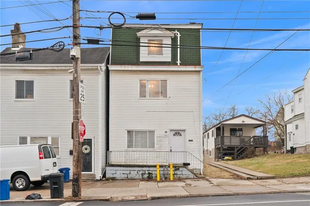 a front view of a house with parking