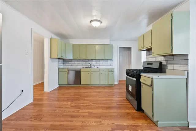 a kitchen with a refrigerator and a stove top oven