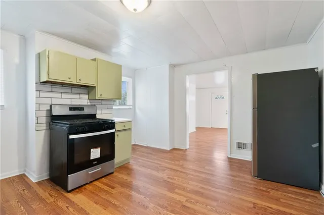 a kitchen with granite countertop a stove and a refrigerator