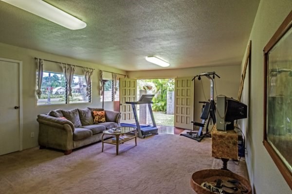 6280 Kalama Road Kapaa, HI 96746 - Photo 15 of 25 a living room with furniture a large window and gym equipment