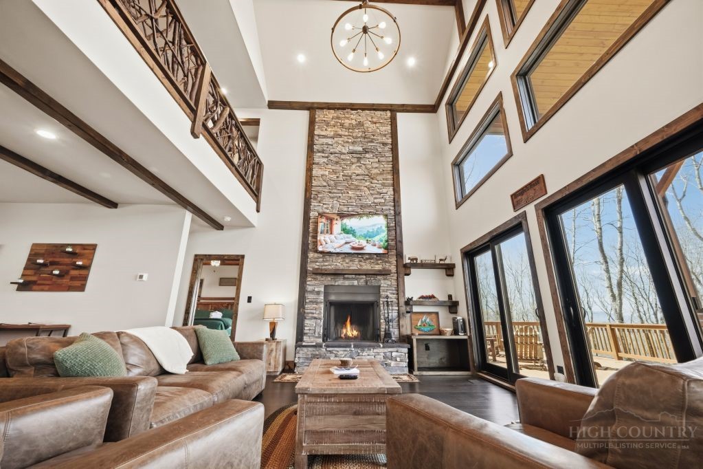 27 Timber Rock Trail Banner Elk, NC 28604 - Photo 12 of 50 a living room with furniture a fireplace and a large window