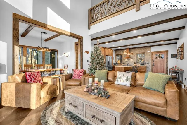 a dining room with furniture a fireplace and wooden floor