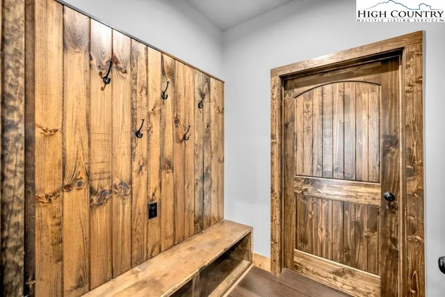 a view of a kitchen with stainless steel appliances granite countertop a sink and wooden floors
