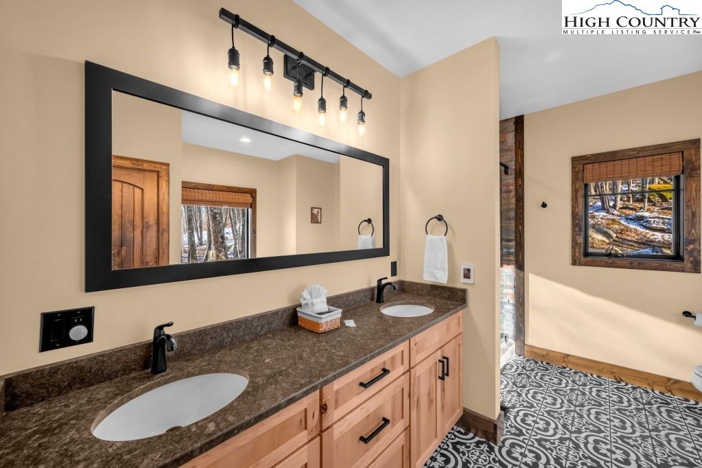 27 Timber Rock Trail Banner Elk, NC 28604 - Photo 21 of 45 a bathroom with double vanity sinks a mirror and a bathtub