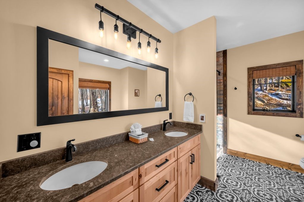 27 Timber Rock Trail Banner Elk, NC 28604 - Photo 22 of 50 a bathroom with double vanity sinks a mirror and a bathtub