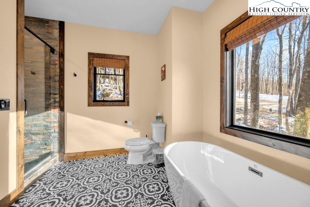 27 Timber Rock Trail Banner Elk, NC 28604 - Photo 22 of 45 a bathroom with a bathtub and a shower