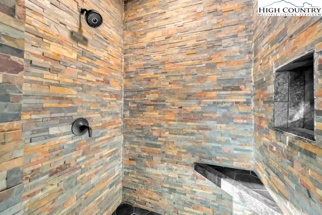 a white bath tub sitting next to a small window