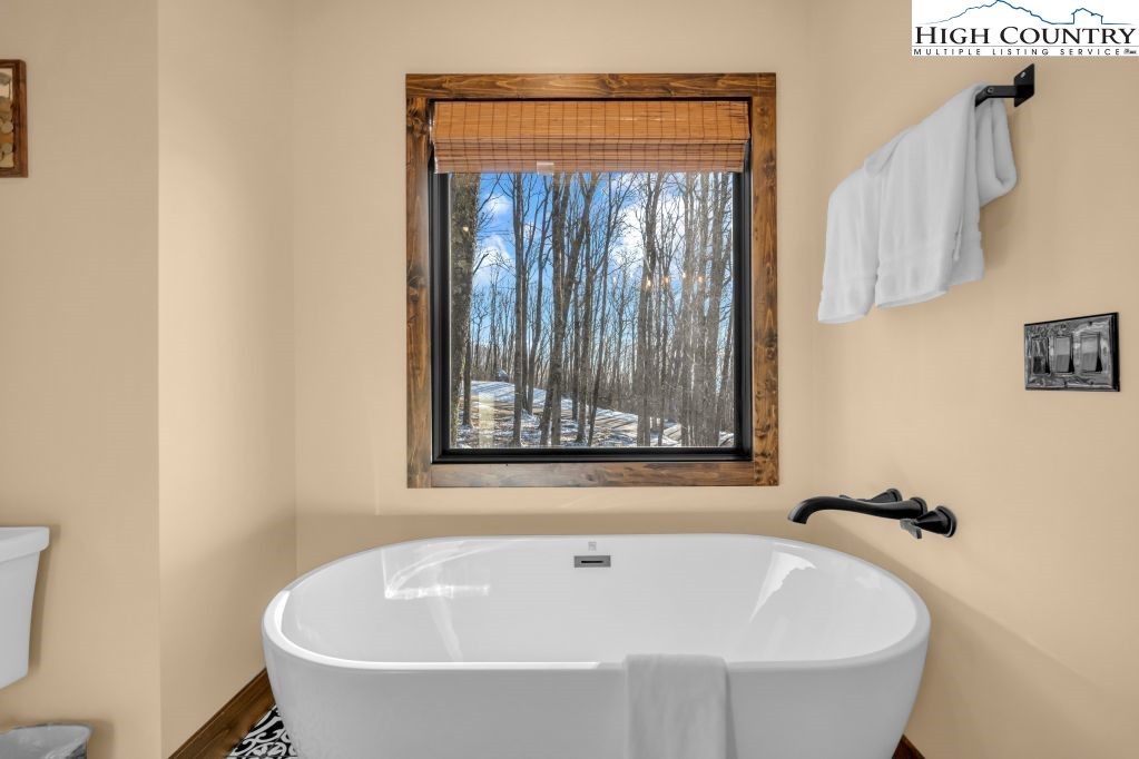 27 Timber Rock Trail Banner Elk, NC 28604 - Photo 24 of 45 a white bath tub sitting next to a small window
