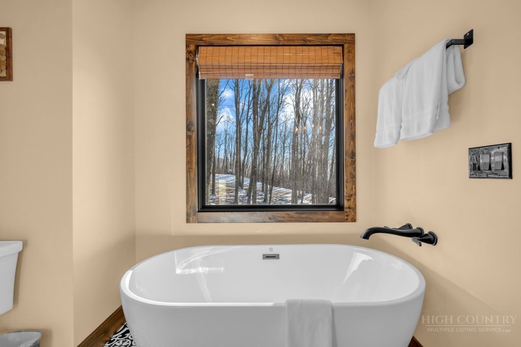 27 Timber Rock Trail Banner Elk, NC 28604 - Photo 25 of 50 a white bath tub sitting next to a small window