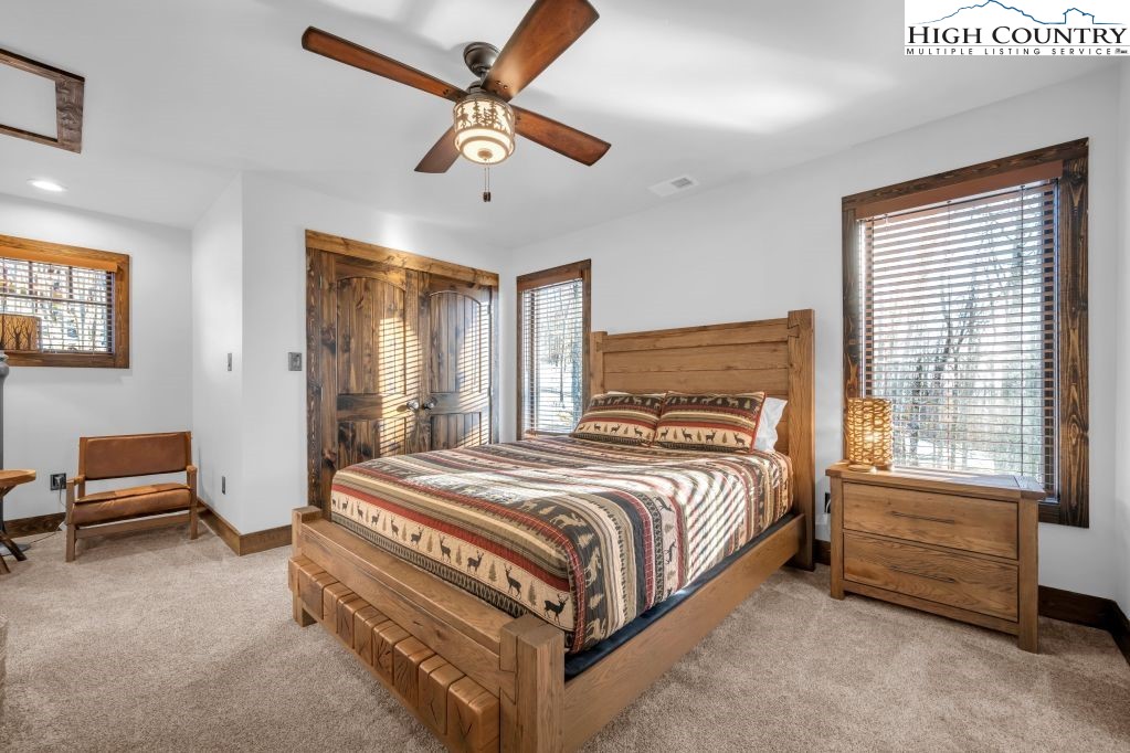 27 Timber Rock Trail Banner Elk, NC 28604 - Photo 30 of 45 a bedroom with a bed and a chandelier