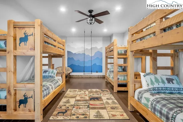 a spacious bedroom with a large bed and a chandelier