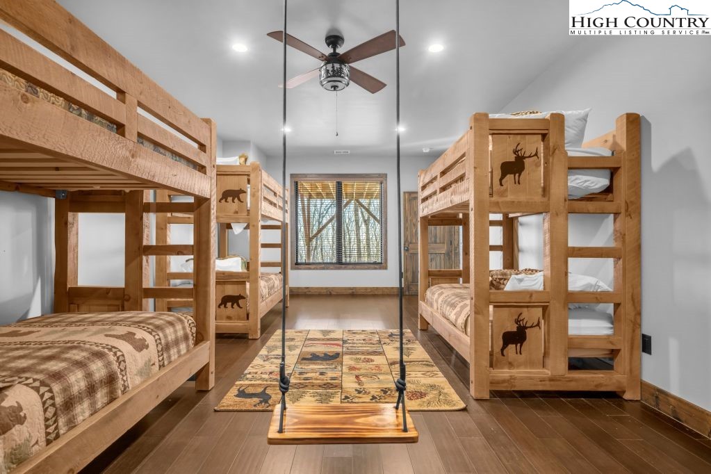 27 Timber Rock Trail Banner Elk, NC 28604 - Photo 37 of 45 a spacious bedroom with a large bed and a chandelier