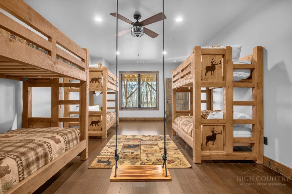 27 Timber Rock Trail Banner Elk, NC 28604 - Photo 43 of 50 a spacious bedroom with a large bed and a chandelier