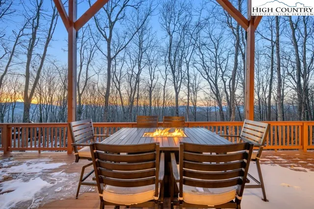 a living room with furniture a fireplace and a large window