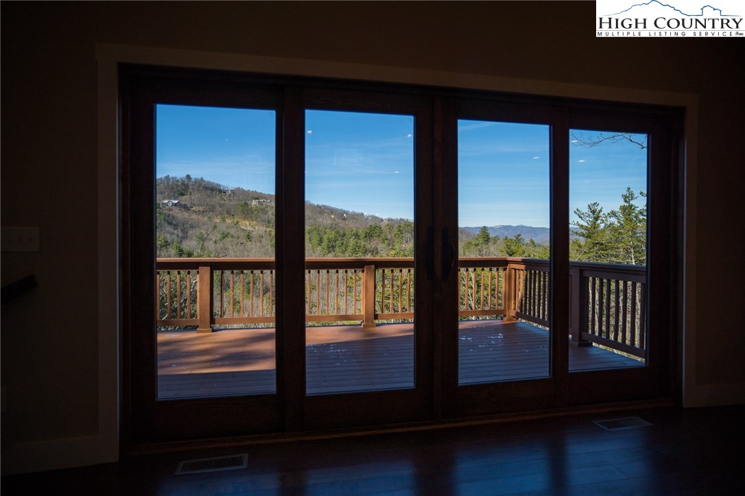 553 Marigold Road Boone, NC 28607 - Photo 8 of 48 a view of a porch with furniture and floor to ceiling window