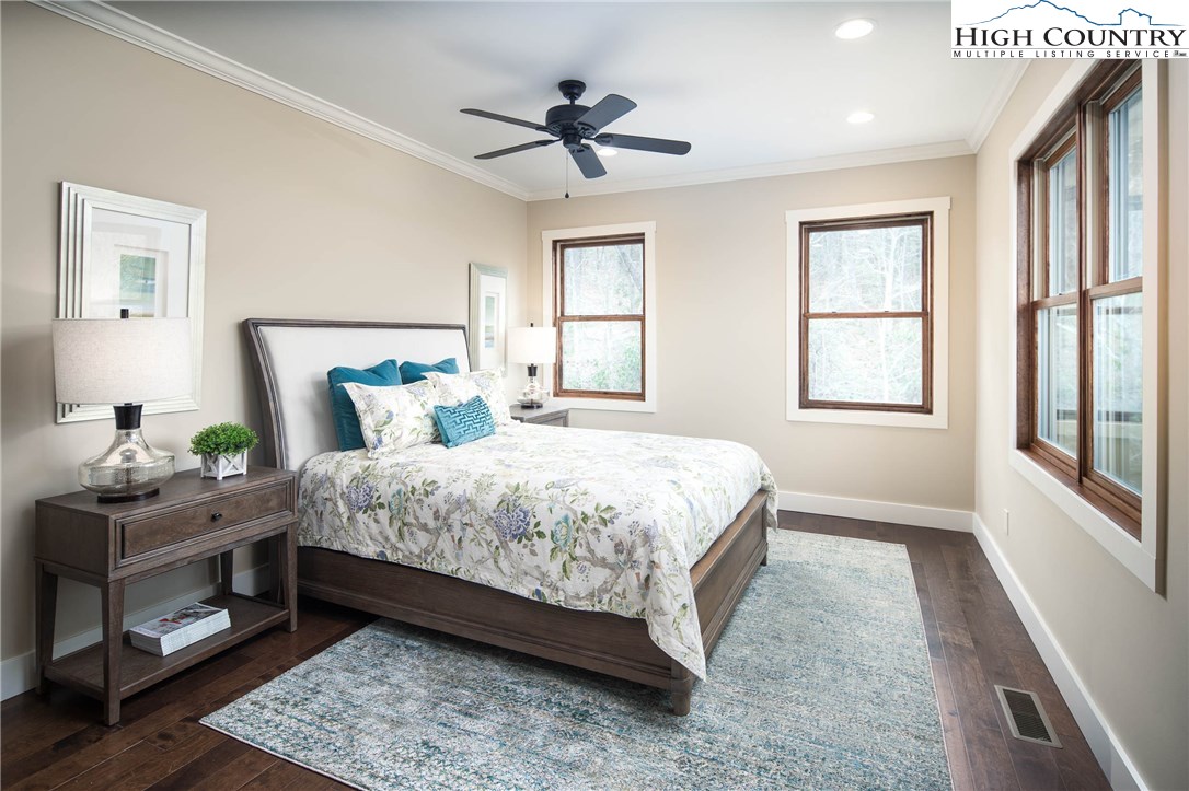 553 Marigold Road Boone, NC 28607 - Photo 10 of 48 a bedroom with a bed chandelier and a window