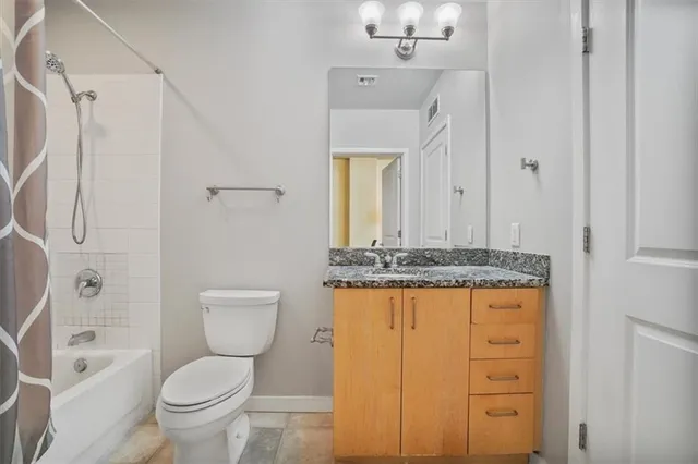 a roof deck with table and chairs under an umbrella