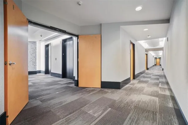 a living room with furniture a bookshelf and a book shelf