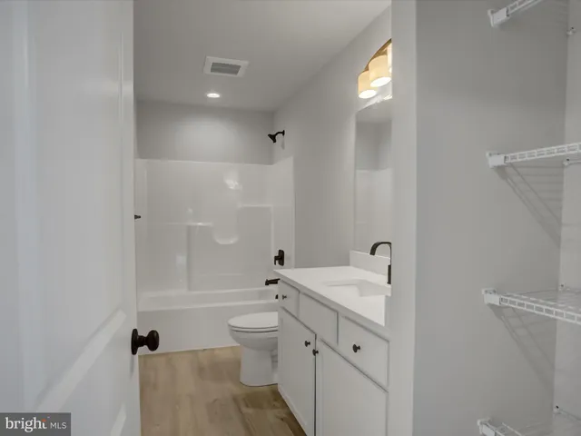 a view of an empty room and closet area