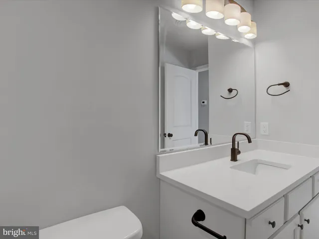 an empty room with closet and windows