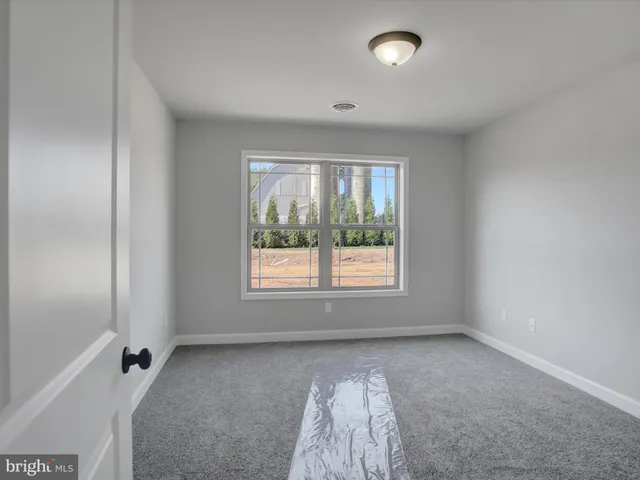 a view of a room with wooden floor and windows