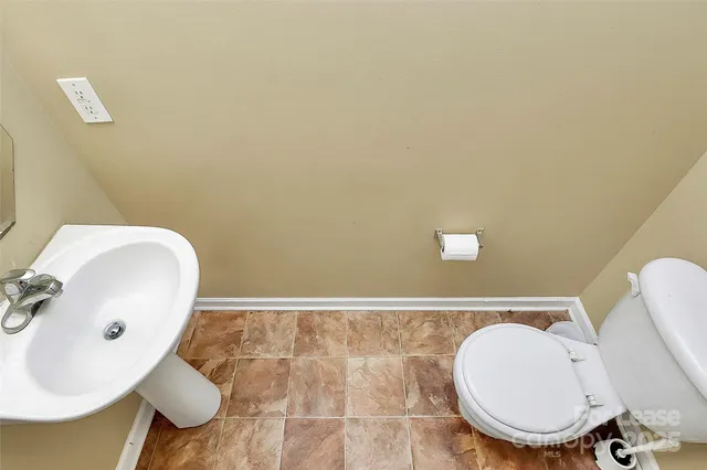 a bathroom with a sink mirror and toilet