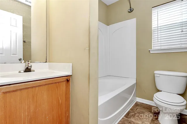 a bathroom with a sink a toilet and bathtub