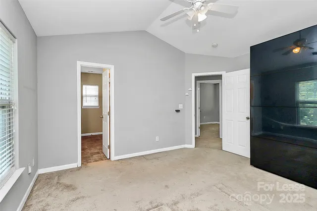 an empty room with fan and entrance