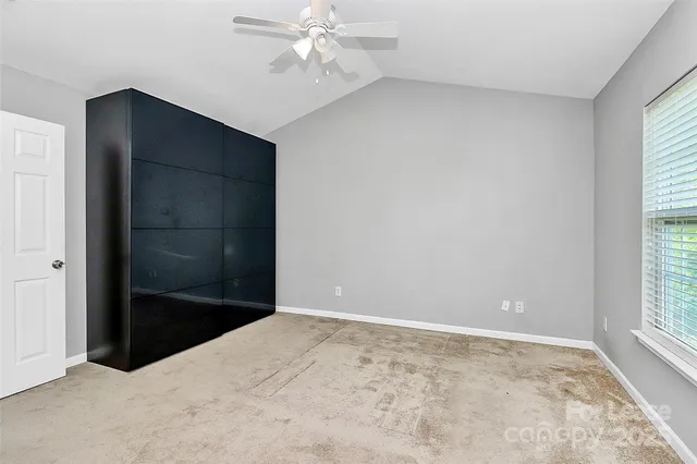 an empty room with windows and closet