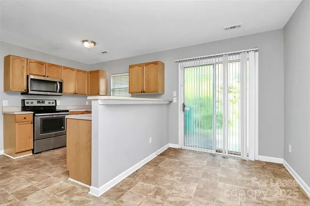 a kitchen with a stove a sink and a microwave