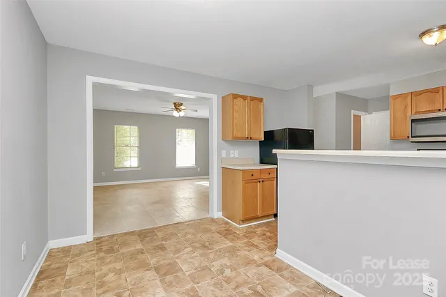 a view of a kitchen with wooden cabinet and a window