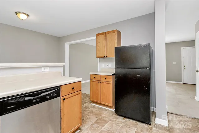 a kitchen with stainless steel appliances a refrigerator and a stove