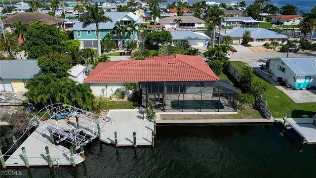 an aerial view of a house with swimming pool patio and outdoor seating