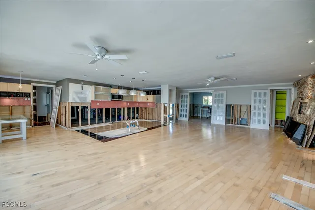 a view of an empty room with furniture and a window