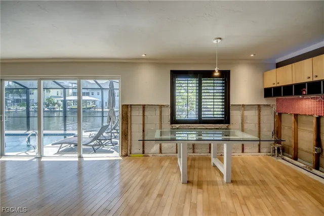 a view of a kitchen with wooden floor and outdoor space