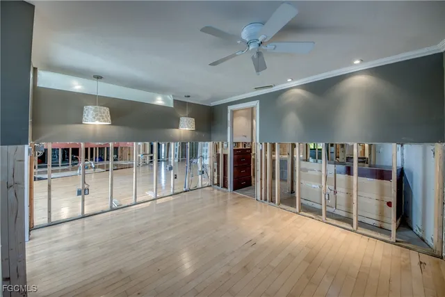 a view of a livingroom with wooden floor and furniture