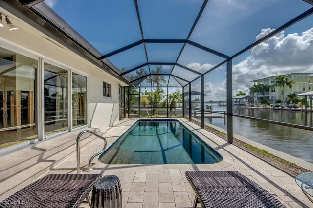 a swimming pool with outdoor seating