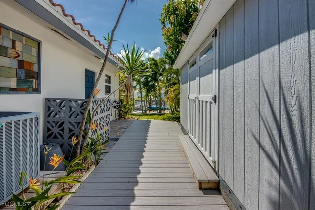 a view of a balcony with wooden floor and fence