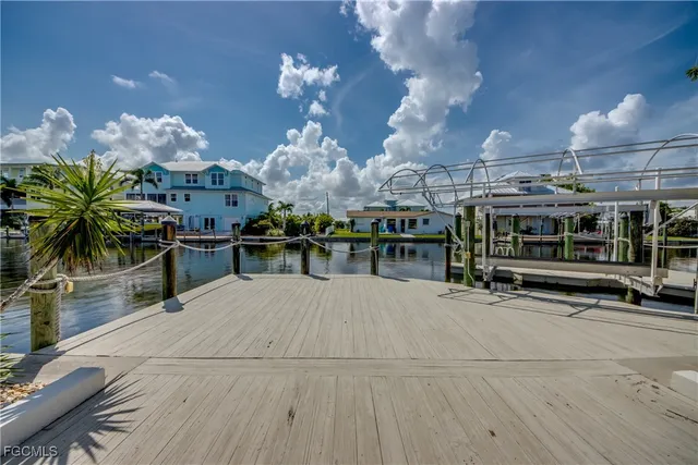 a view of a patio with table and chairs under an umbrella