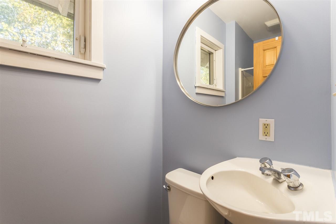 700 Method Road Raleigh, NC 27607 - Photo 19 of 29 a bathroom with a sink and a mirror