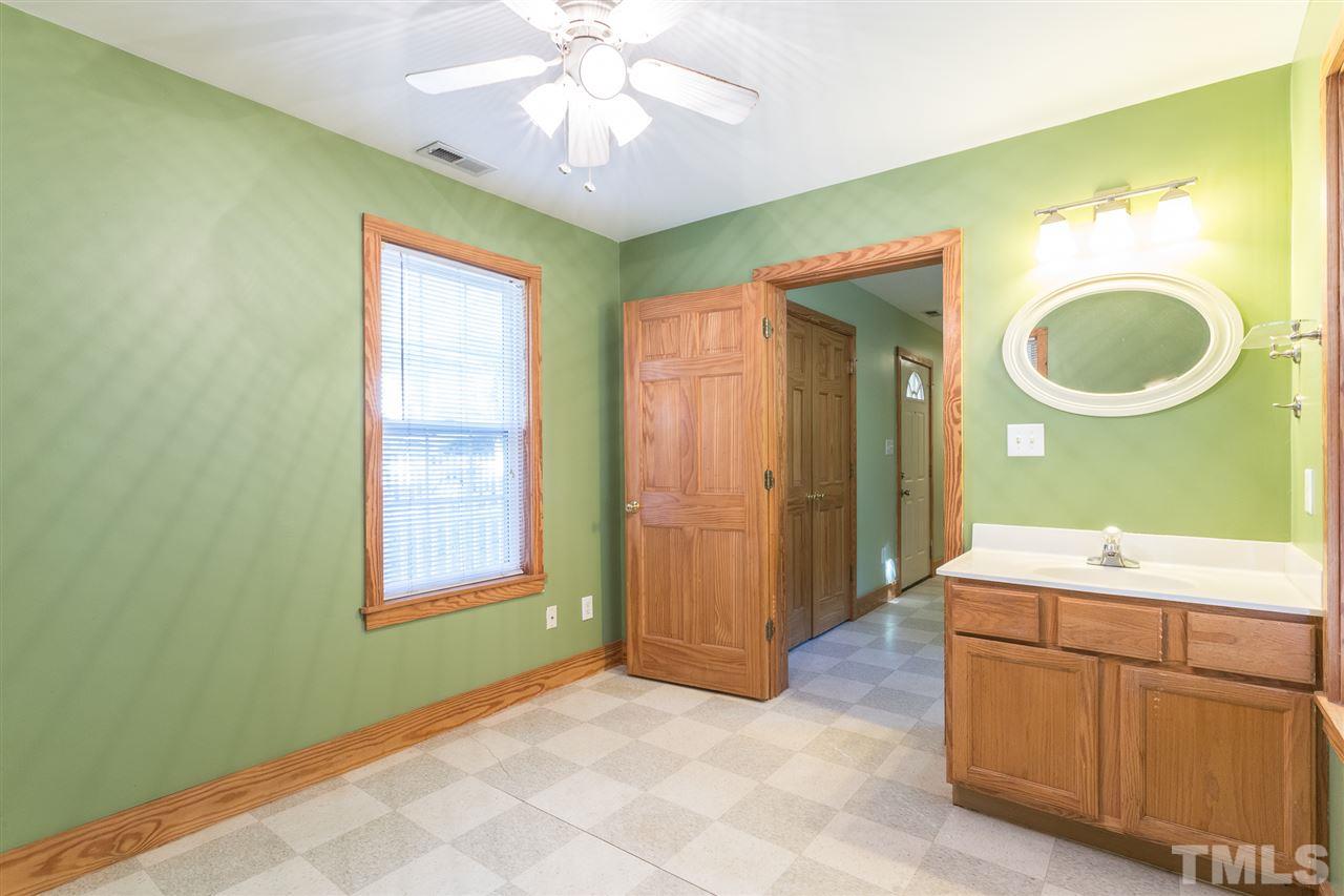 700 Method Road Raleigh, NC 27607 - Photo 26 of 29 a bathroom with a sink a toilet and a mirror
