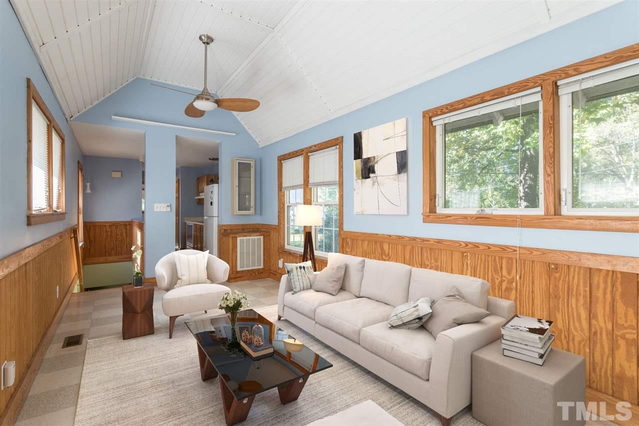 700 Method Road Raleigh, NC 27607 - Photo 9 of 29 a living room with furniture a window and a chandelier