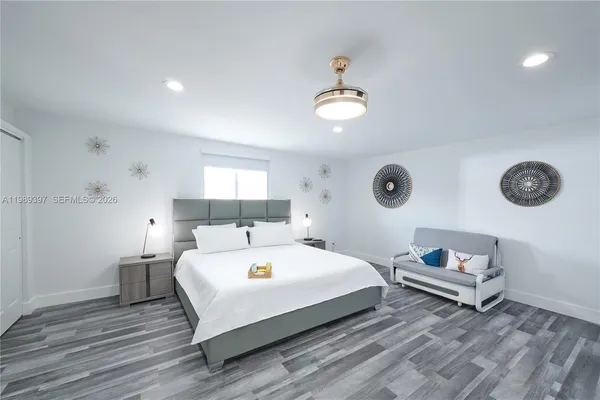 a spacious bedroom with a bed and a window