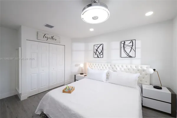 a bedroom with a bed and a couch