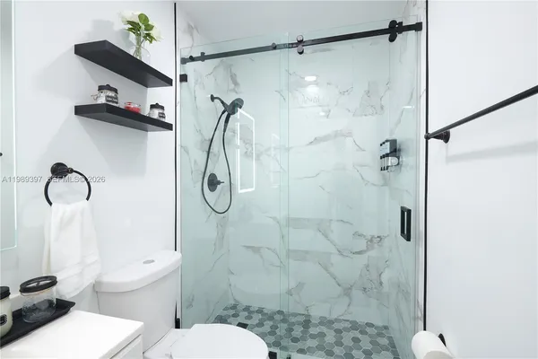 a bathroom with a toilet sink and shower